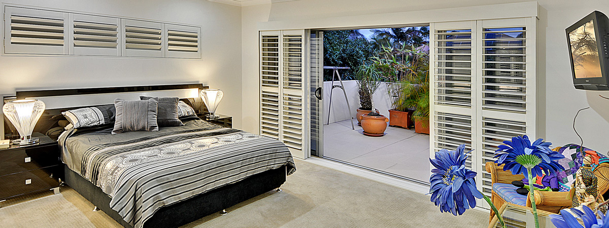 Premium Blinds, Shutters and Curtains - A sunshine coast bedroom featuring premium shutters
